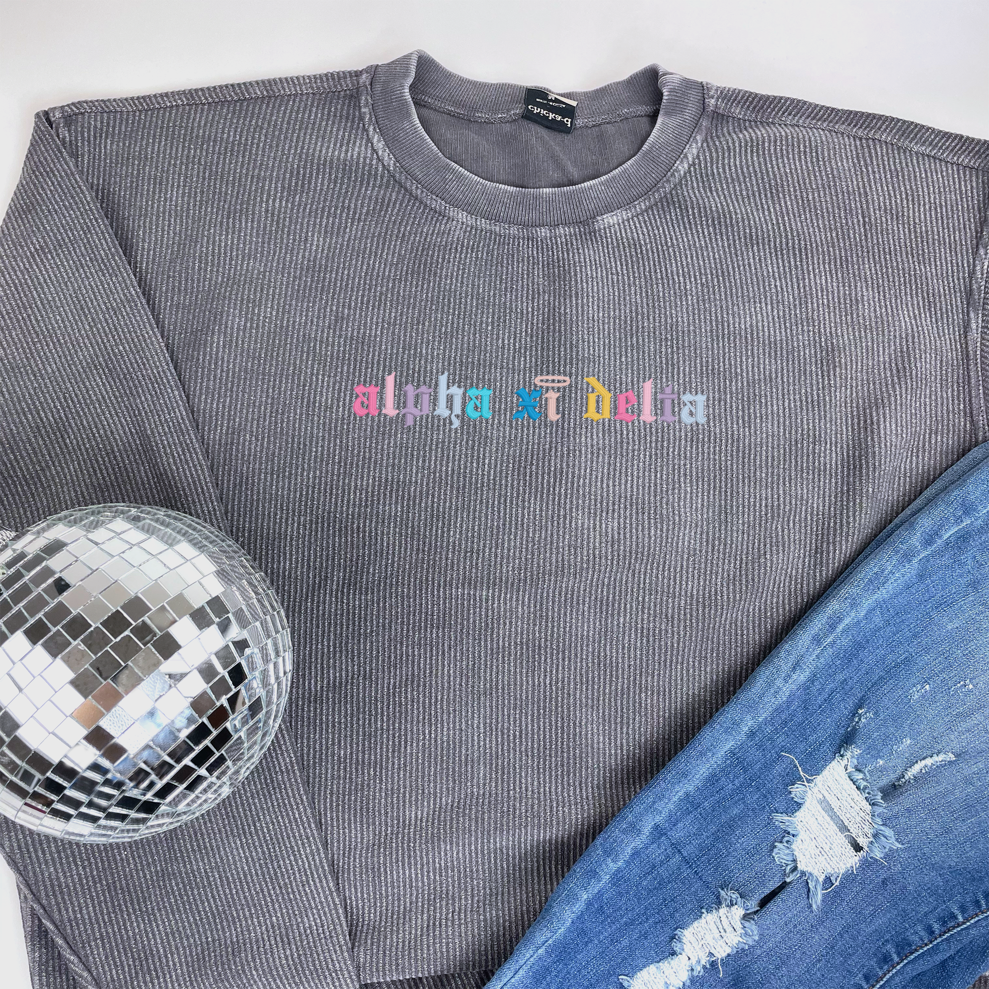 a disco ball sitting next to a sweatshirt