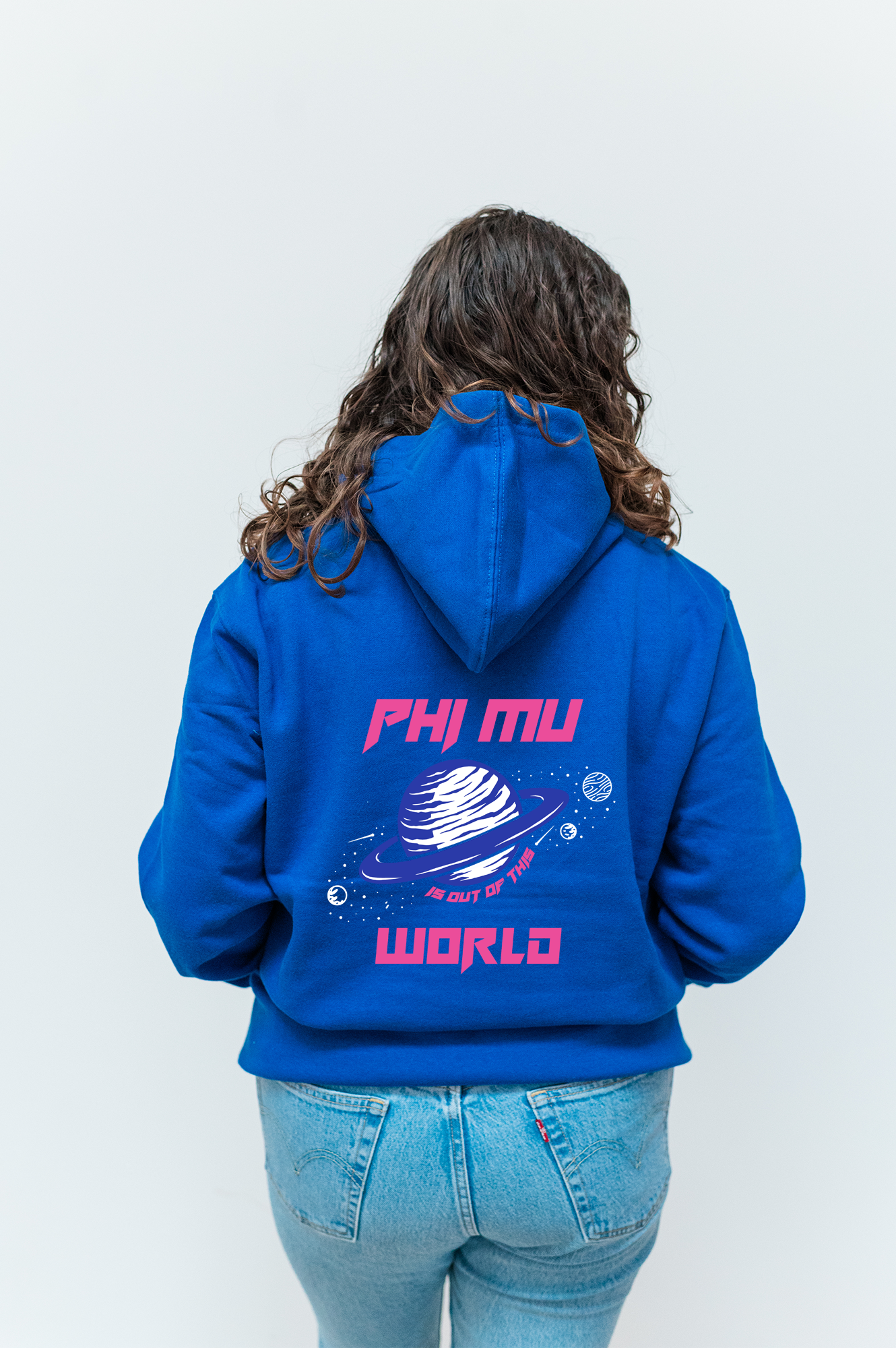 a woman wearing a blue hoodie with a pink logo on it
