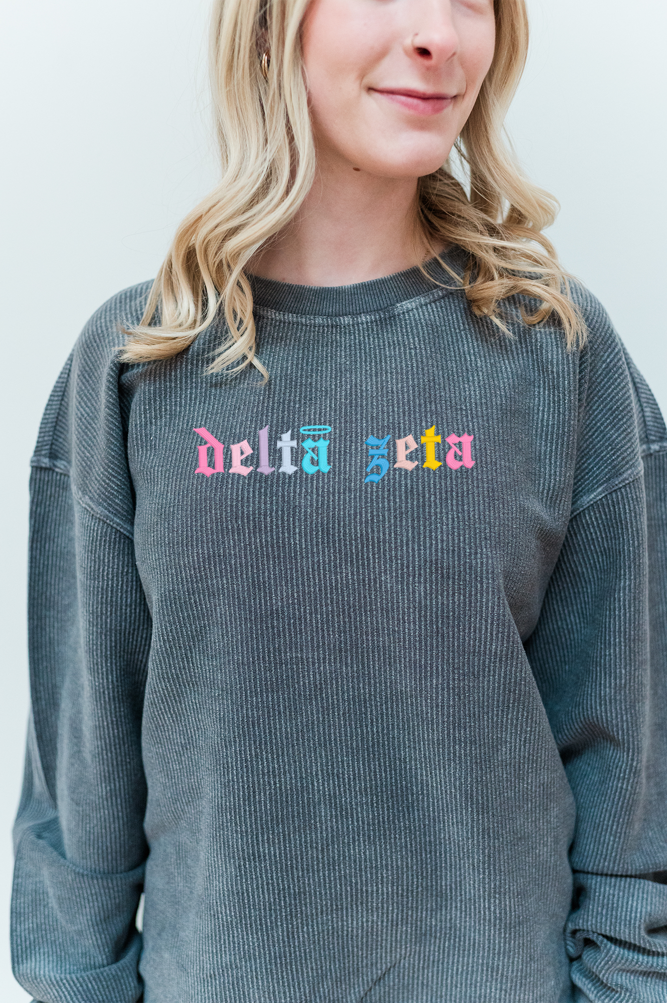 a woman wearing a sweatshirt with the word delta on it