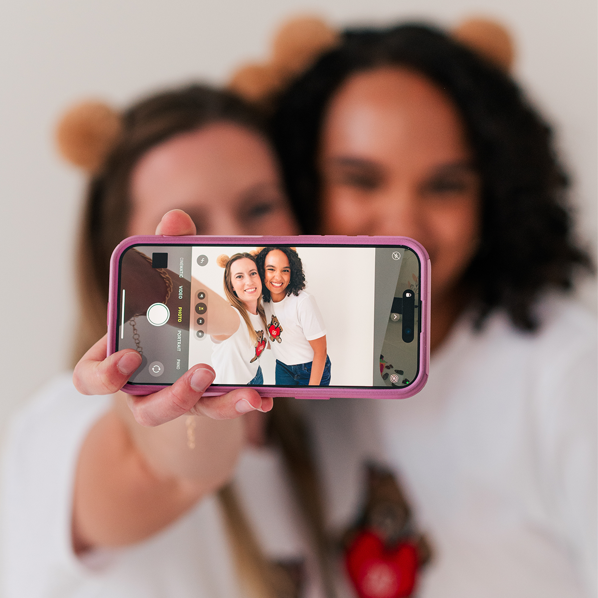 a woman taking a picture of herself with her phone