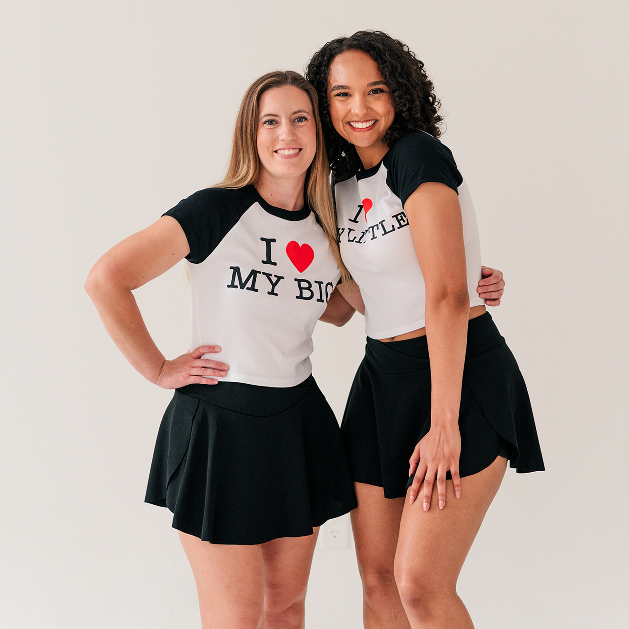 two women posing for a picture with their arms around each other