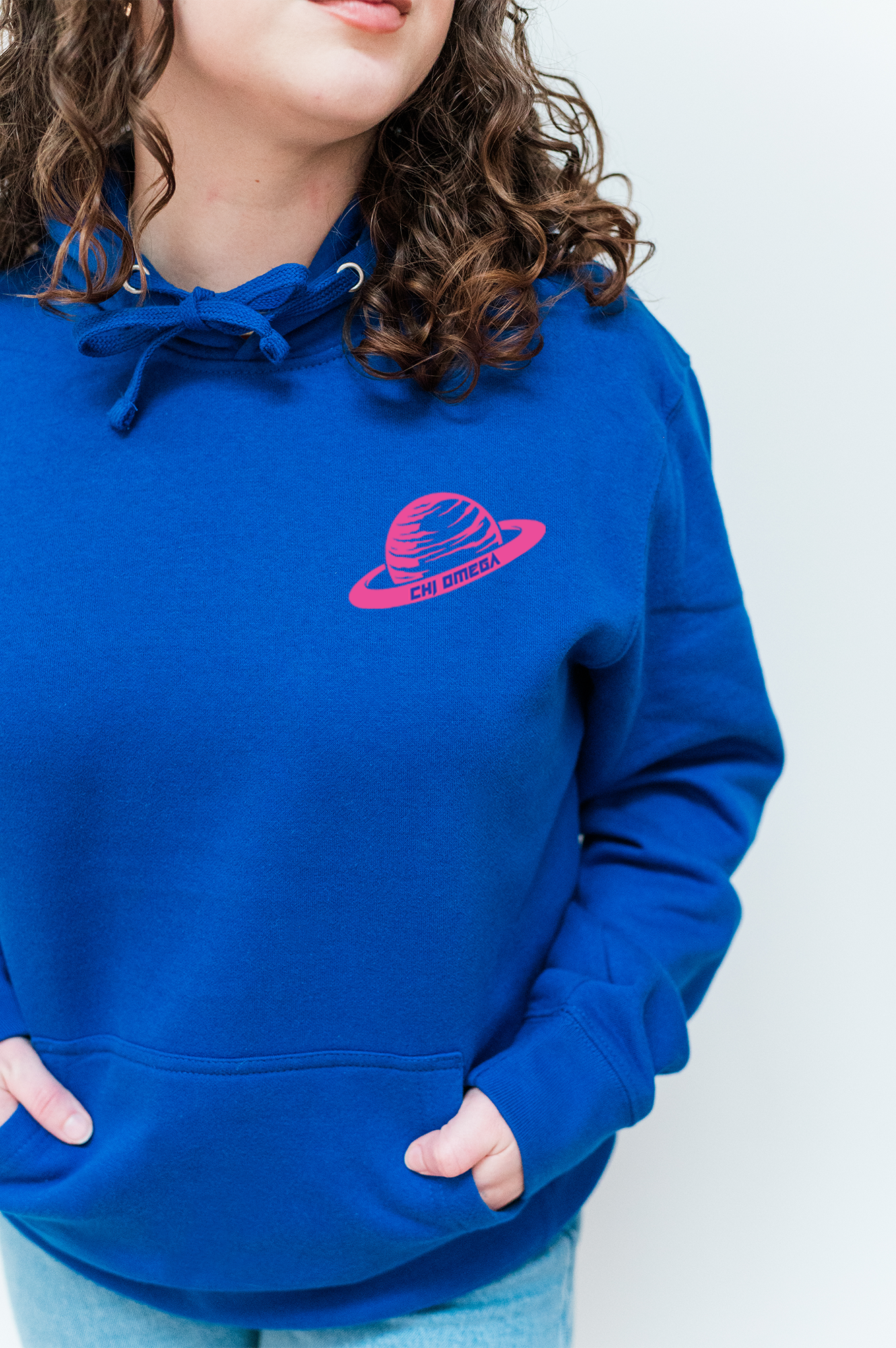 a woman wearing a blue sweatshirt with a red logo on it