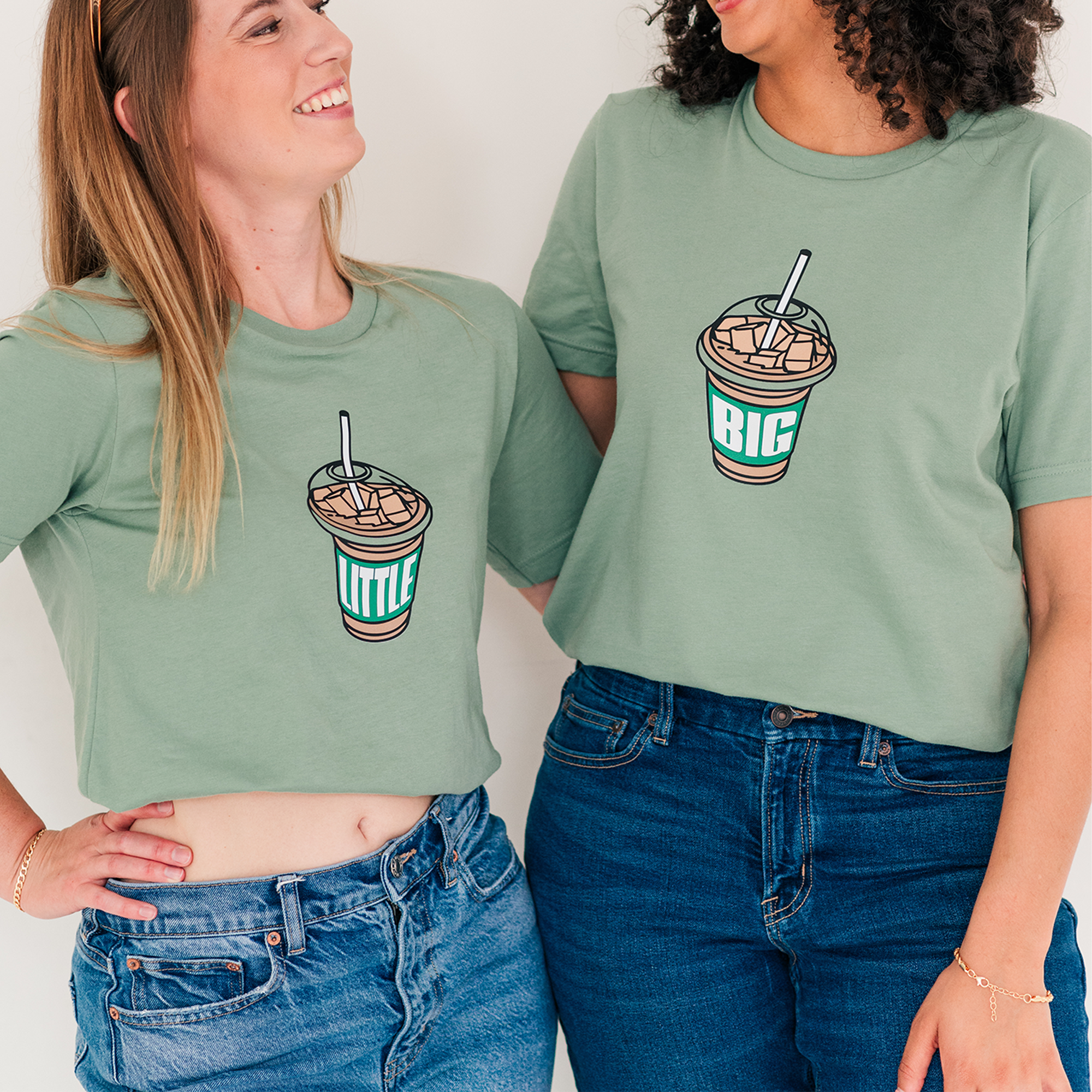 two women standing next to each other wearing matching shirts