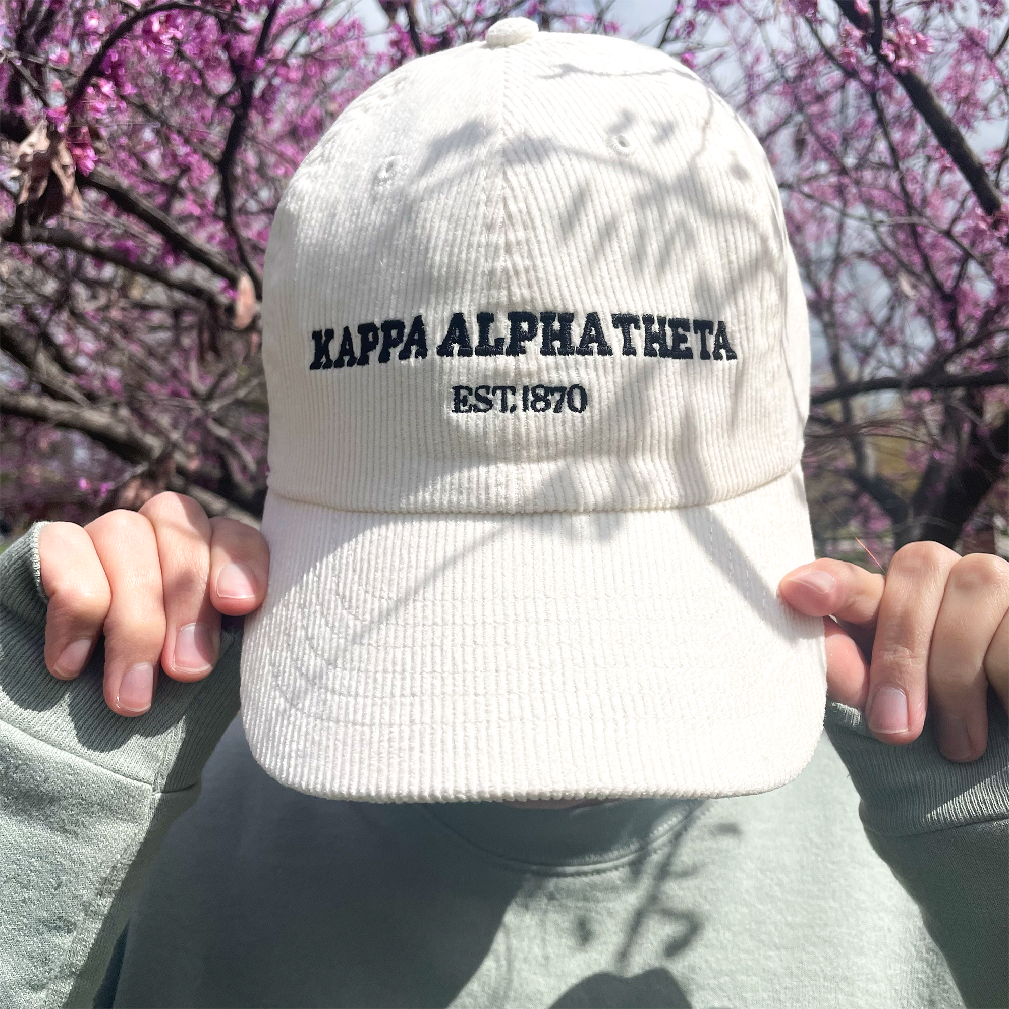 a person wearing a hat with the words kapaa alphabet on it